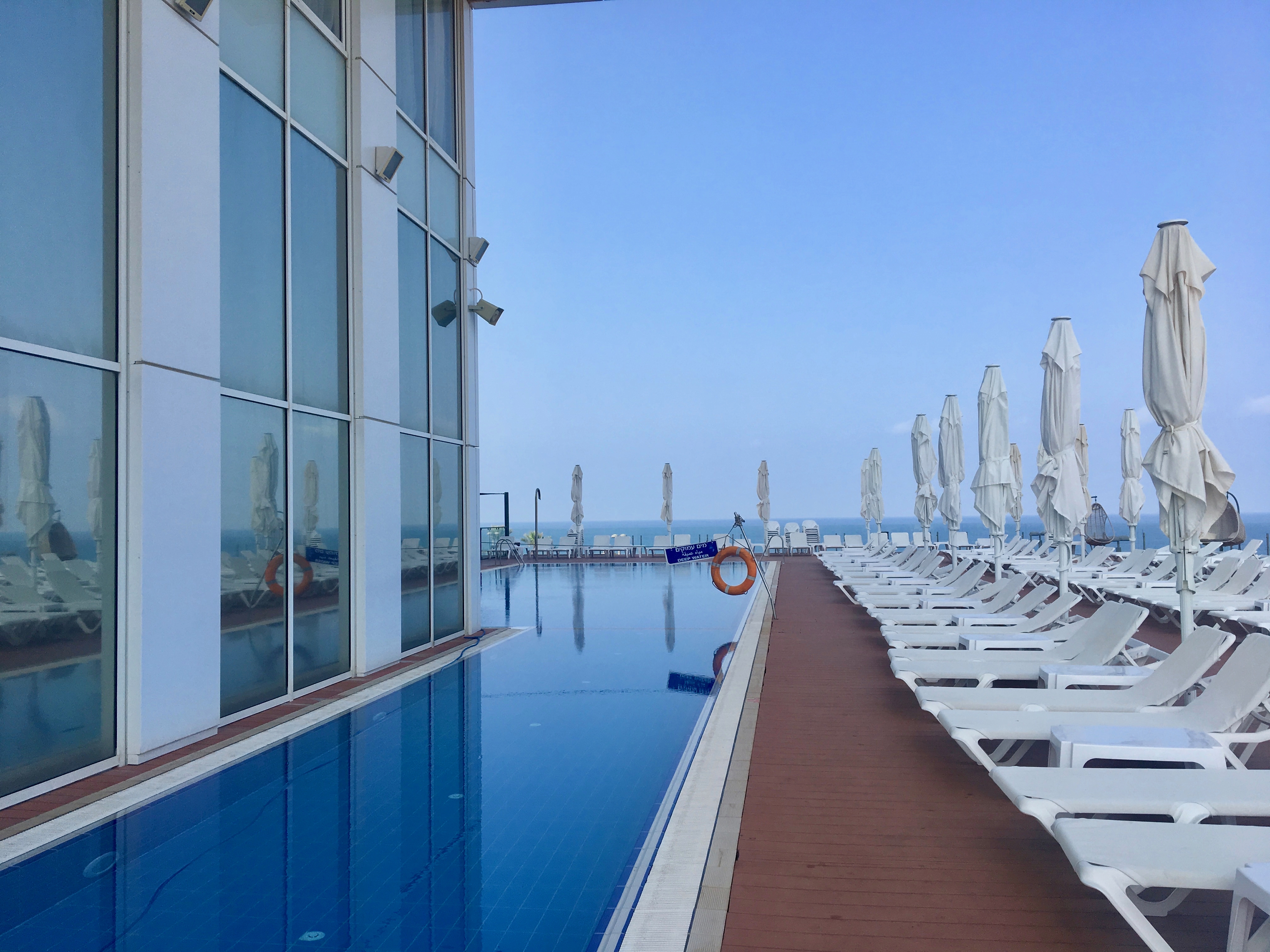 The view of a calm pool in Netanya, Israel, looking out onto the Mediterranean Sea.